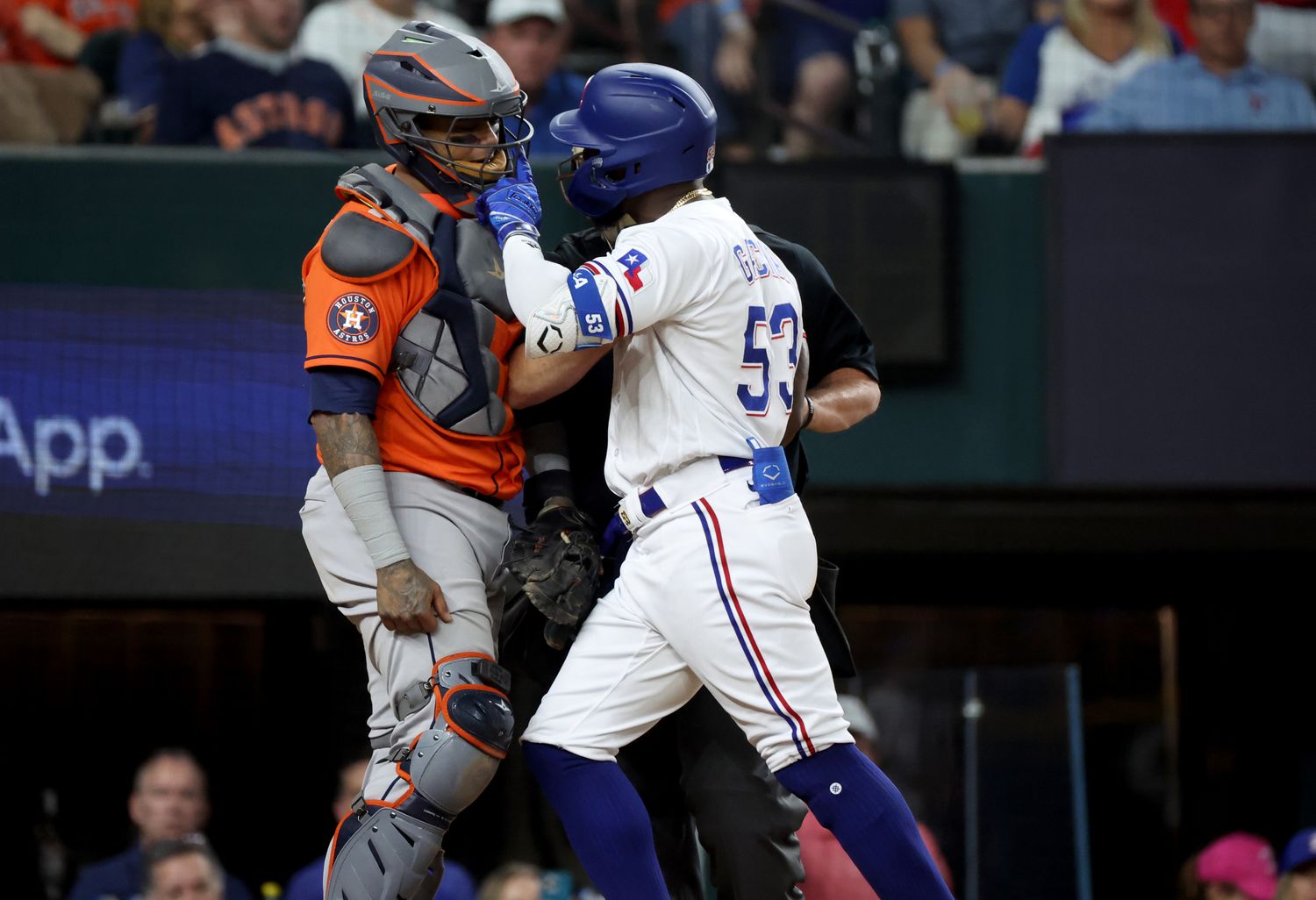 Oct 20, 2023; Arlington, Texas, USA; Texas Rangers right fielder Adolis Garcia (53) confronts Houston Astros catcher Martin Maldonado (15) after being hit by a pitch during the eighth inning of game five in the ALCS for the 2023 MLB playoffs at Globe Life Field. Mandatory Credit: Kevin Jairaj-USA TODAY Sports